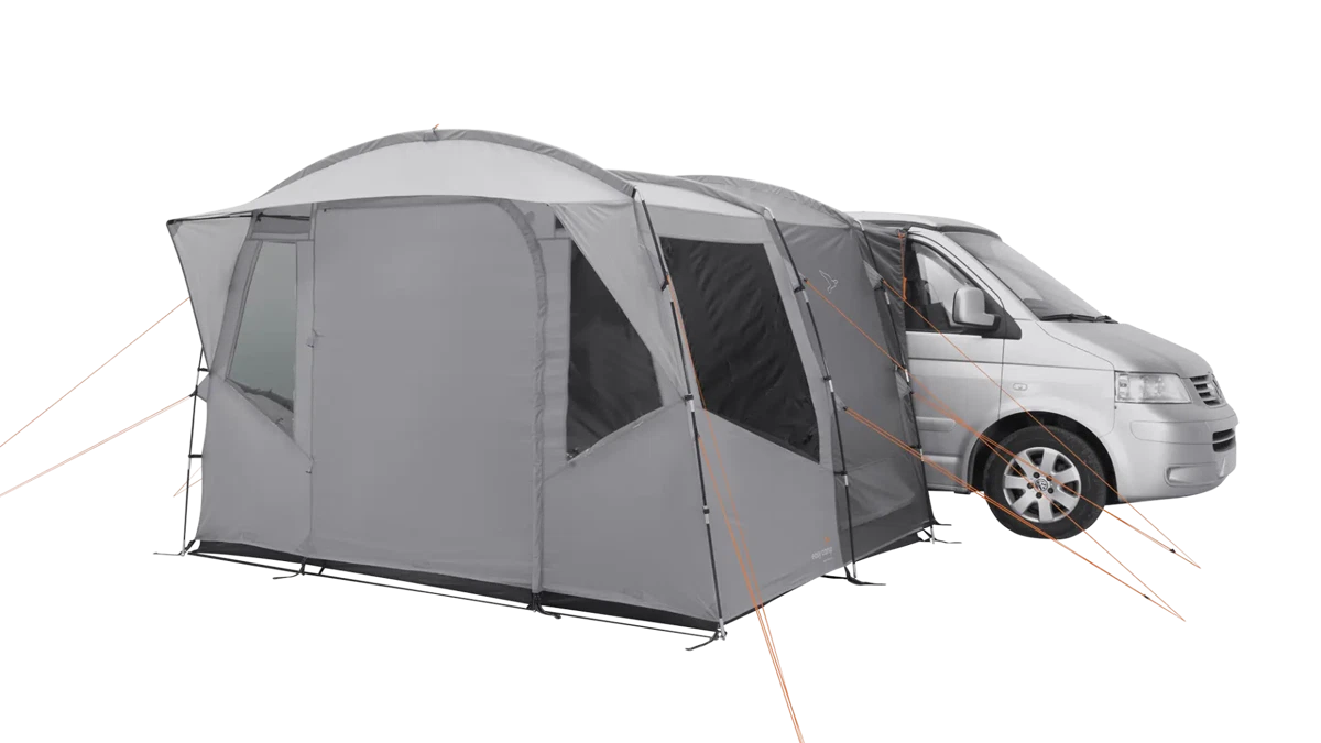 Easy Camp Reine drive-away van awning set up on a campsite, showcasing its spacious fabric extension and sturdy support poles.