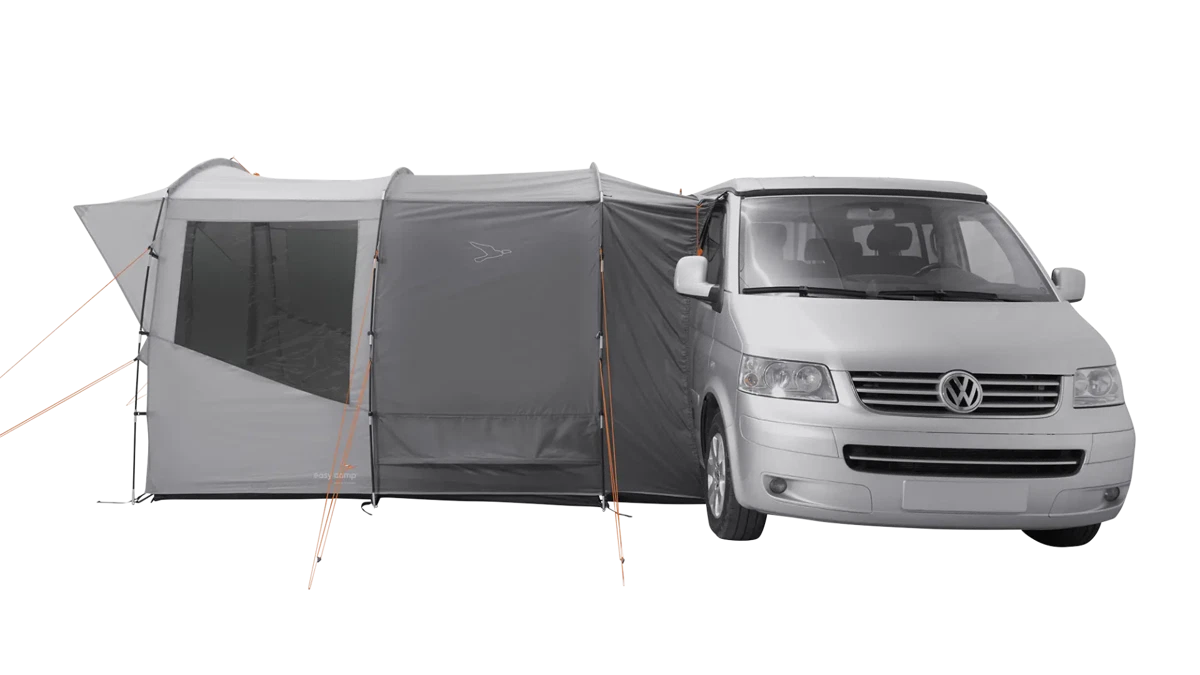 Easy Camp Reine Drive-away Van Awning set up outdoors, showcasing its spacious fabric extension and attachment to a camper van.