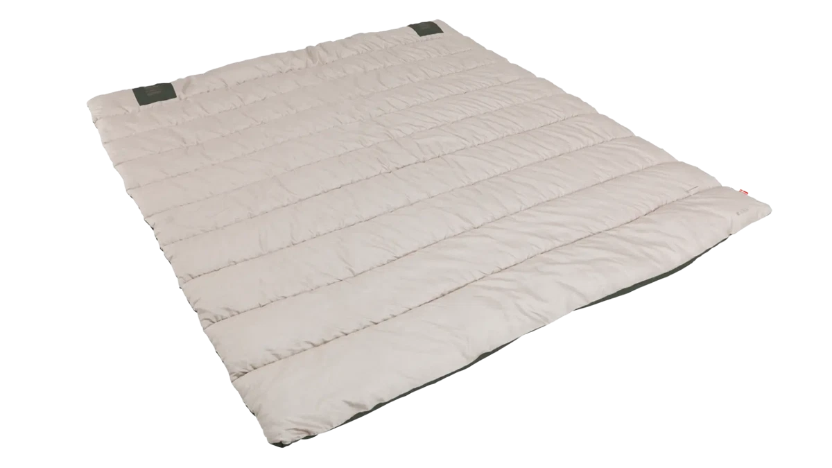 Outwell Campion double leaf green duvet spread out on a bed, showcasing its soft fabric and cozy design for camping or home use.