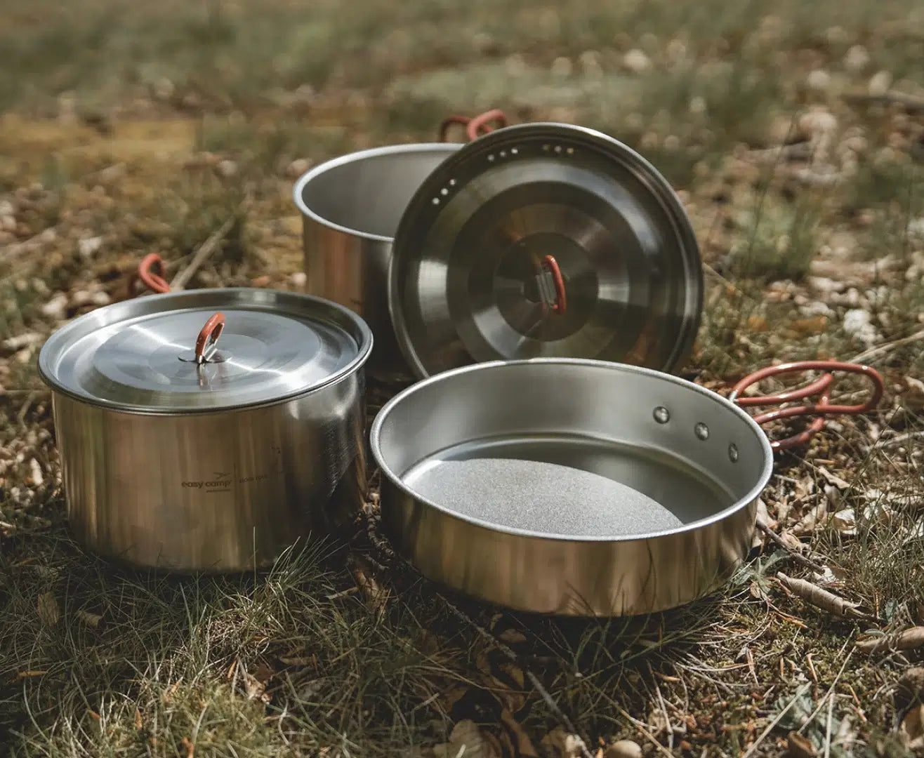 Easy Camp Moss Tour Cook Set kitchenware with pots, pans, and utensils for camping cooking, shown in the image.