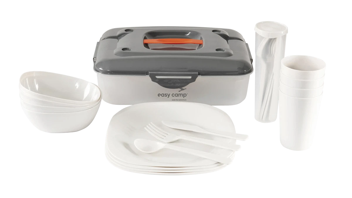 Easy Camp Picnic Box M tableware set with plates, cups, and utensils displayed on a picnic table.