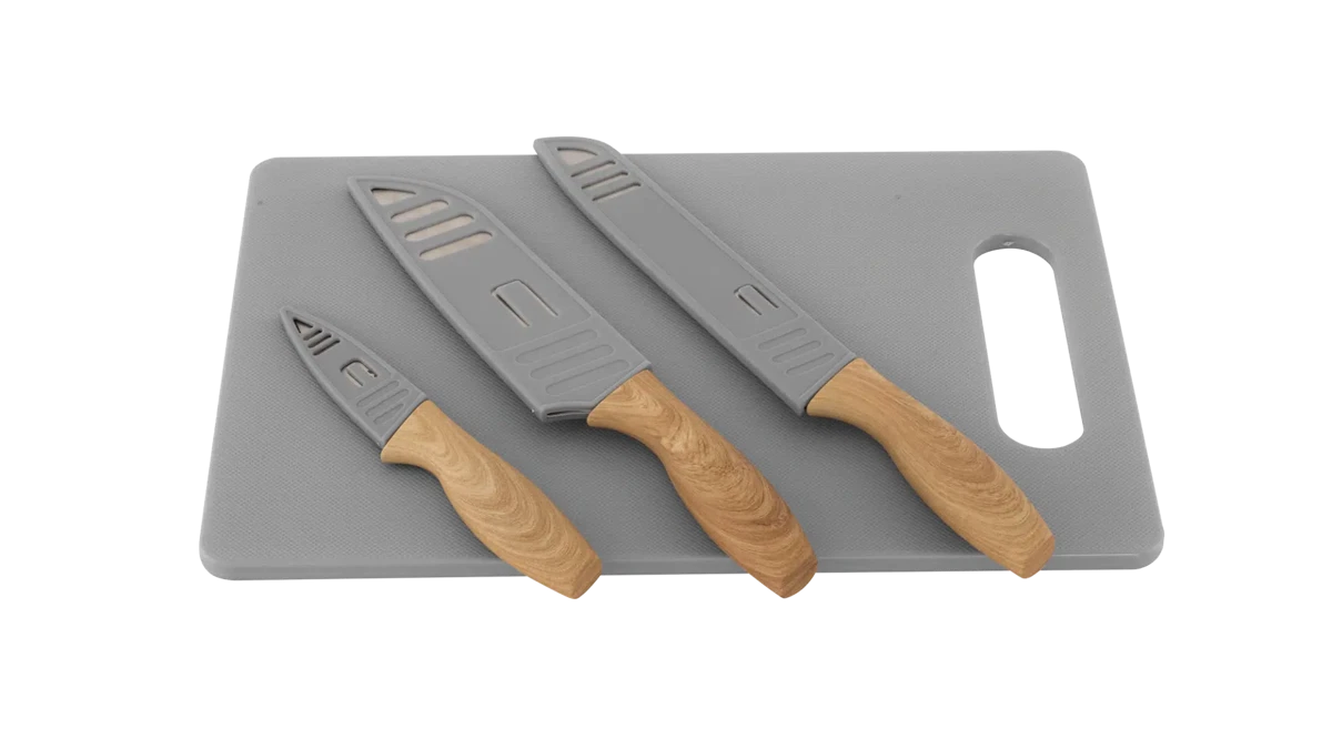 Outwell Caldas knife set with matching cutting board, featuring stainless steel blades and ergonomic handles for kitchen use.