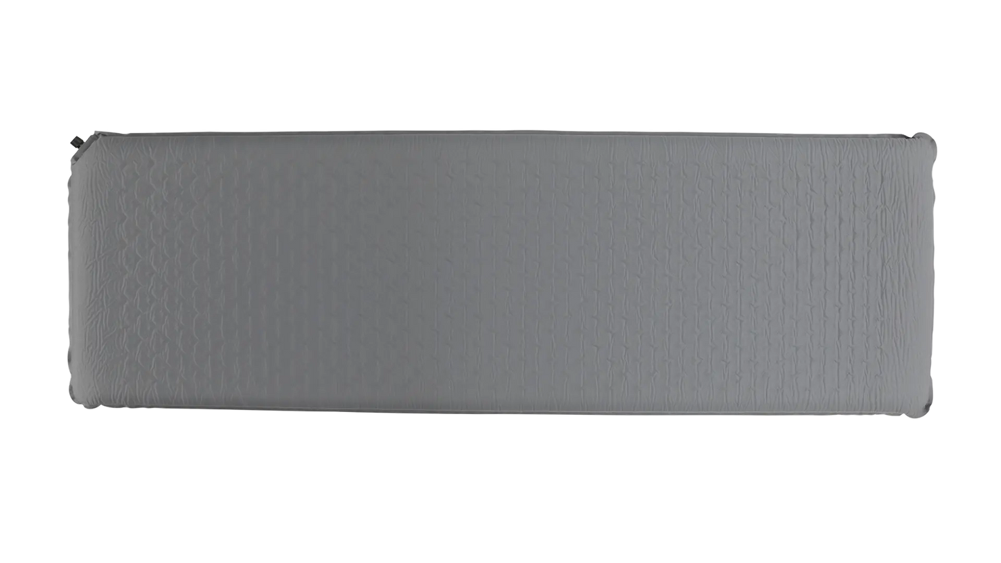 Robens Campground 75 self-inflating mat laid out on a campsite, showcasing its compact design and padded surface for camping comfort.