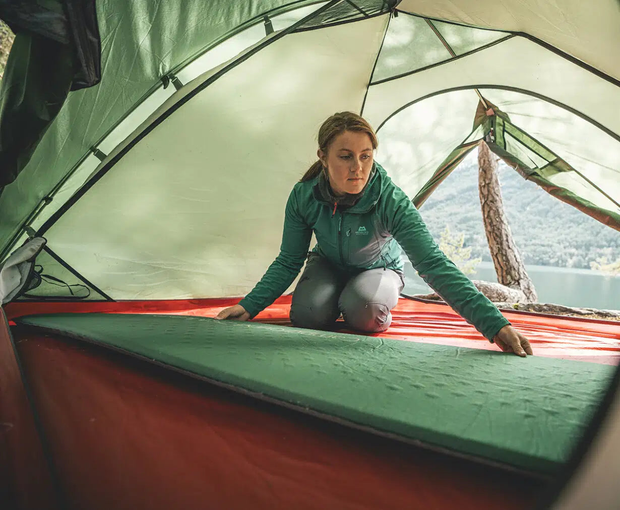 Robens Campground 75 self-inflating camping mat laid out on a tent floor, showing its durable fabric and thick padding for comfort.