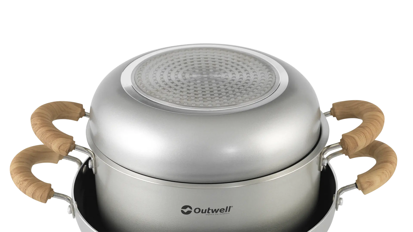 Outwell Feast Ceramic Set XL kitchenware including plates, bowls, and mugs arranged on a wooden table.