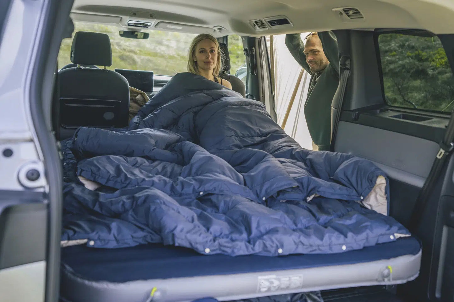 Outwell Caldera Double Blue duvet laid out on a bed, showcasing its soft fabric and cozy design for comfortable sleeping.